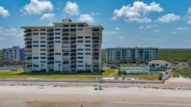 5499 S Atlantic Ave Unit 104, New Smyrna Beach, FL 32169 - view of building exterior featuring a water view and a beach view