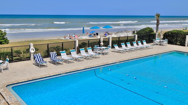 5499 S Atlantic Ave Unit 104, New Smyrna Beach, FL 32169 - pool featuring fence, a water view, and a view of the beach