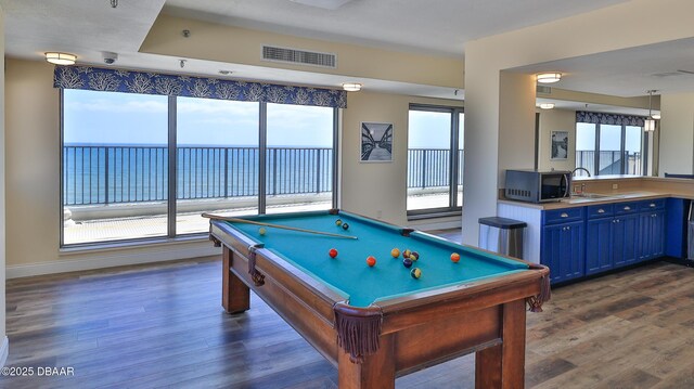 5499 S Atlantic Ave Unit 104, New Smyrna Beach, FL 32169 - playroom featuring billiards, visible vents, a sink, and dark wood-type flooring