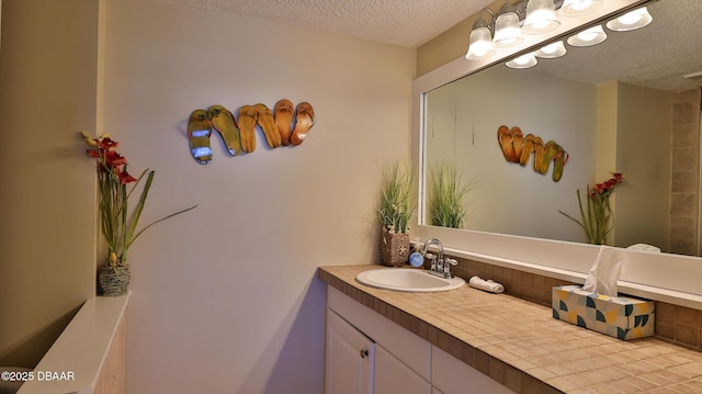 5499 S Atlantic Ave Unit 104, New Smyrna Beach, FL 32169 - bathroom featuring vanity and a textured ceiling