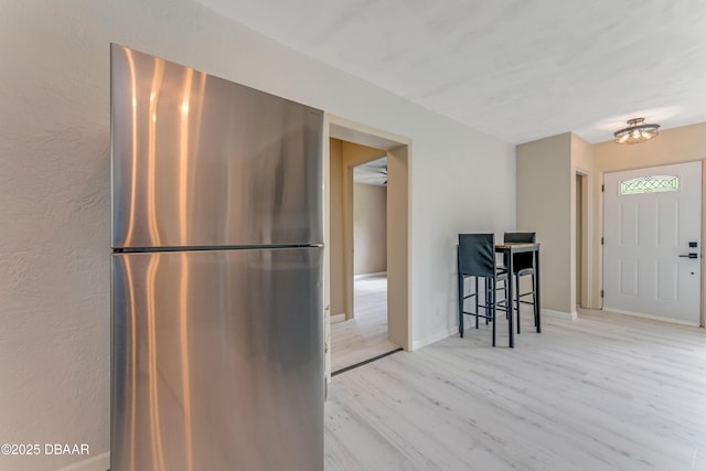 182 Grove St, Ormond Beach, FL 32174 - kitchen featuring freestanding refrigerator and light wood finished floors