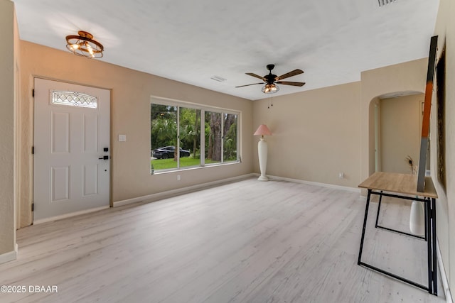 182 Grove St, Ormond Beach, FL 32174 - foyer with wood finished floors, arched walkways, baseboards, and ceiling fan