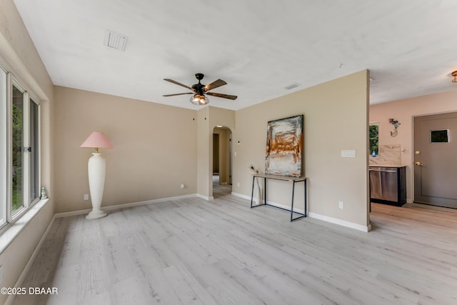 182 Grove St, Ormond Beach, FL 32174 - unfurnished living room featuring arched walkways, light wood-type flooring, and plenty of natural light