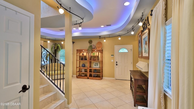 1929 Spruce Creek Lndg, Port Orange, FL 32128 - entrance foyer with track lighting, a raised ceiling, light tile patterned flooring, stairway, and recessed lighting