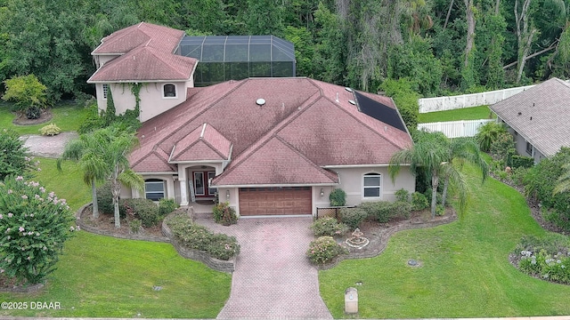 1929 Spruce Creek Lndg, Port Orange, FL 32128 - view of front of house featuring an attached garage, stucco siding, decorative driveway, and a lanai