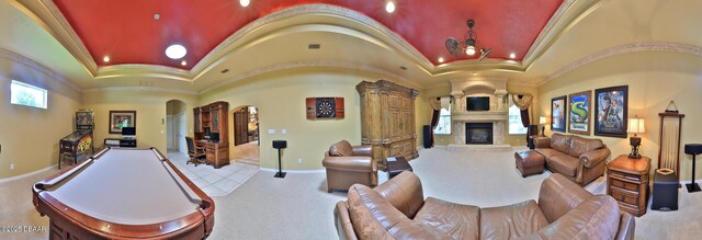 1929 Spruce Creek Lndg, Port Orange, FL 32128 - rec room featuring arched walkways, ornamental molding, vaulted ceiling, a large fireplace, and carpet flooring