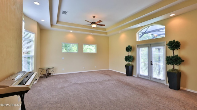 1929 Spruce Creek Lndg, Port Orange, FL 32128 - carpeted empty room with french doors, ceiling fan, a tray ceiling, and recessed lighting