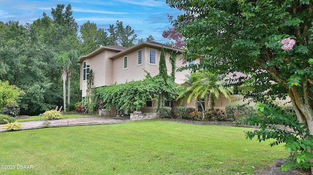 1929 Spruce Creek Lndg, Port Orange, FL 32128 - view of front of house with stucco siding and a front lawn