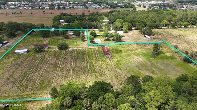 birds eye view of property with a rural view