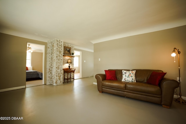 living room featuring baseboards and finished concrete floors