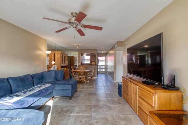 living room featuring tile patterned floors and ceiling fan