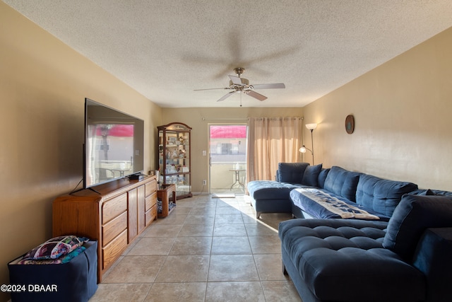 tiled living room with a textured ceiling and ceiling fan