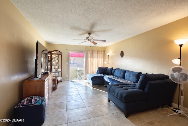 tiled living room featuring a textured ceiling and ceiling fan