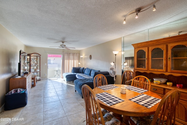 dining area with rail lighting, ceiling fan, light tile patterned flooring, and a textured ceiling