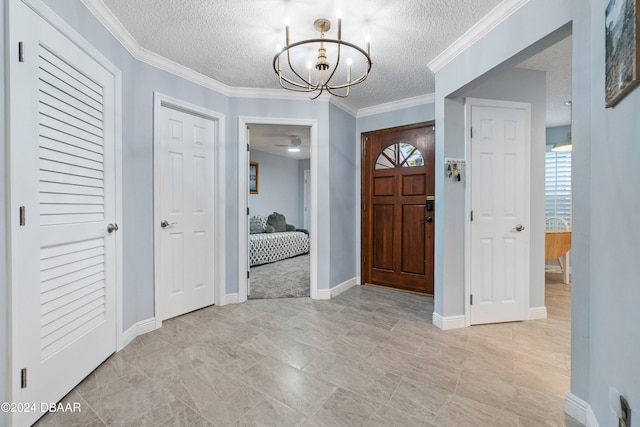 entrance foyer featuring crown molding, a textured ceiling, and a chandelier