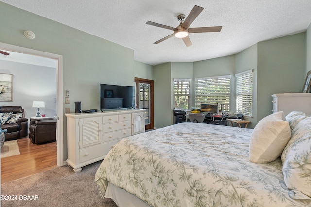 carpeted bedroom with a textured ceiling and ceiling fan