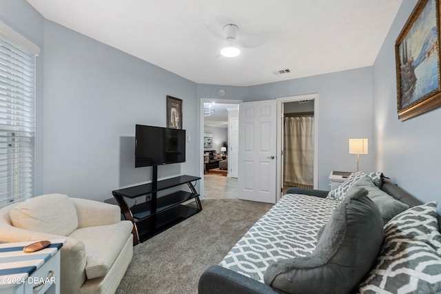 carpeted living room featuring ceiling fan