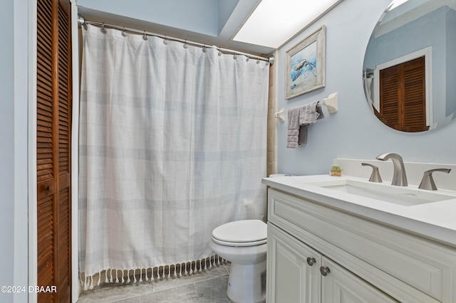 bathroom with tile patterned floors, vanity, curtained shower, and toilet