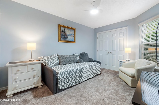 carpeted living room featuring ceiling fan