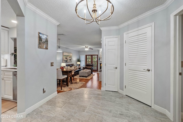 hallway featuring a textured ceiling, a chandelier, crown molding, and light hardwood / wood-style flooring