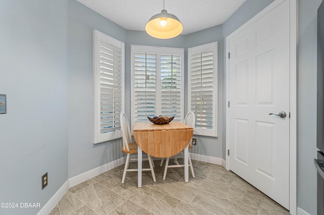 dining room with a textured ceiling