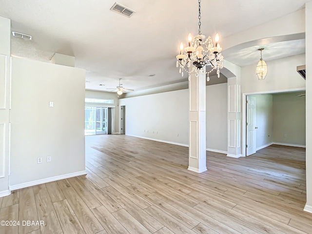 46 Coquina Point Dr, Ormond Beach, FL 32174 - unfurnished living room with ceiling fan with notable chandelier and light hardwood / wood-style floors