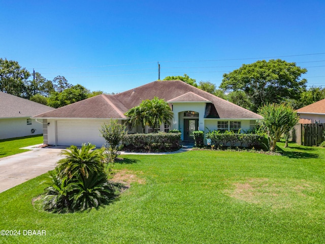 ranch-style home with a garage and a front yard