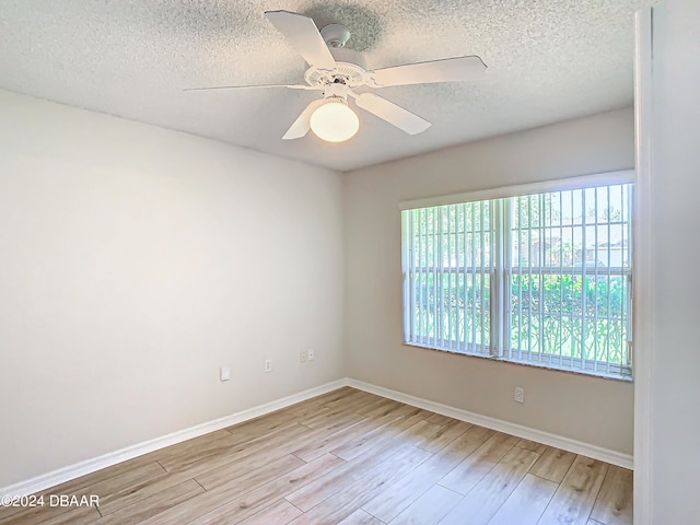 46 Coquina Point Dr, Ormond Beach, FL 32174 - spare room with a textured ceiling, light wood-type flooring, and ceiling fan