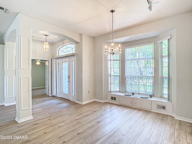 46 Coquina Point Dr, Ormond Beach, FL 32174 - interior space featuring a healthy amount of sunlight, light wood-type flooring, and a textured ceiling