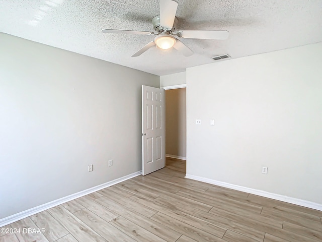 46 Coquina Point Dr, Ormond Beach, FL 32174 - unfurnished room with a textured ceiling, ceiling fan, and light hardwood / wood-style flooring