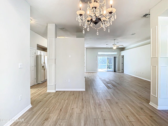 46 Coquina Point Dr, Ormond Beach, FL 32174 - unfurnished living room featuring light hardwood / wood-style floors and ceiling fan with notable chandelier