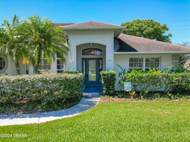 46 Coquina Point Dr, Ormond Beach, FL 32174 - view of exterior entry with a yard