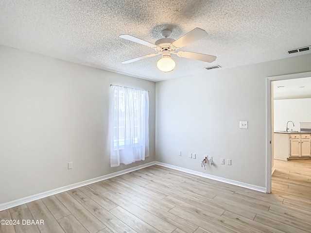 46 Coquina Point Dr, Ormond Beach, FL 32174 - spare room featuring light hardwood / wood-style flooring, a textured ceiling, ceiling fan, and sink