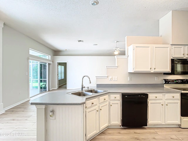 46 Coquina Point Dr, Ormond Beach, FL 32174 - kitchen featuring white cabinets, kitchen peninsula, black appliances, sink, and light wood-type flooring
