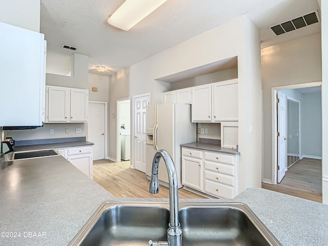 46 Coquina Point Dr, Ormond Beach, FL 32174 - kitchen with light hardwood / wood-style floors, sink, white refrigerator with ice dispenser, and white cabinets