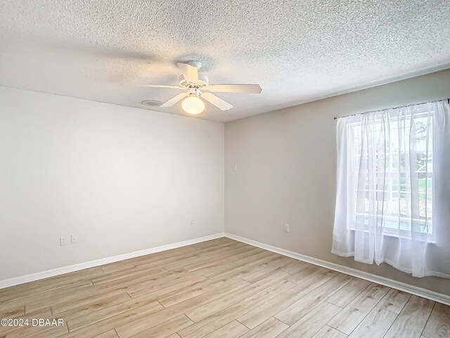 46 Coquina Point Dr, Ormond Beach, FL 32174 - empty room featuring light wood-type flooring, a textured ceiling, and ceiling fan