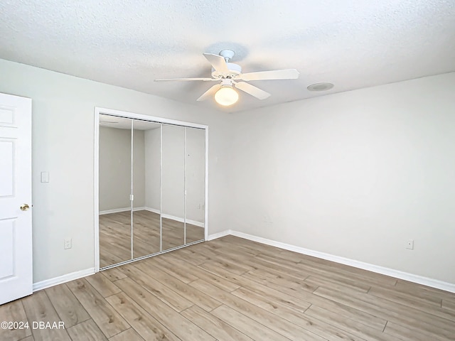 46 Coquina Point Dr, Ormond Beach, FL 32174 - unfurnished bedroom with a textured ceiling, light hardwood / wood-style floors, ceiling fan, and a closet