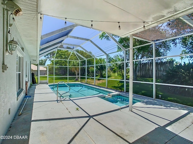 view of swimming pool with a patio area, a lawn, and a lanai