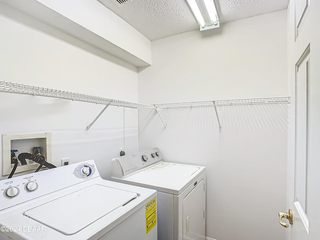 46 Coquina Point Dr, Ormond Beach, FL 32174 - laundry room featuring a textured ceiling and independent washer and dryer
