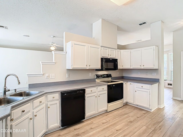 46 Coquina Point Dr, Ormond Beach, FL 32174 - kitchen with white cabinetry, light wood-type flooring, black appliances, and sink