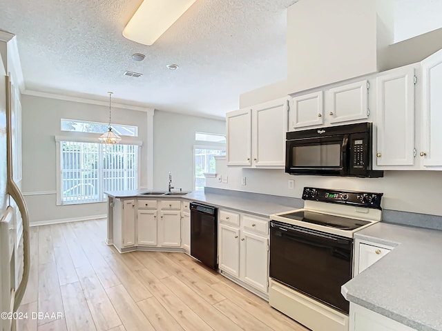 46 Coquina Point Dr, Ormond Beach, FL 32174 - kitchen featuring black appliances, white cabinetry, pendant lighting, and light wood-type flooring