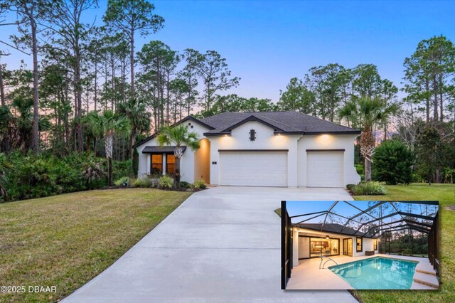 view of front of house featuring a garage and a yard