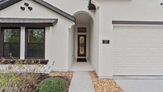 view of exterior entry featuring a garage