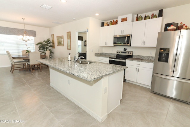 1313 Middle Lake Dr, Ormond Beach, FL 32174 - kitchen featuring stainless steel appliances, a sink, a chandelier, white cabinets, and recessed lighting