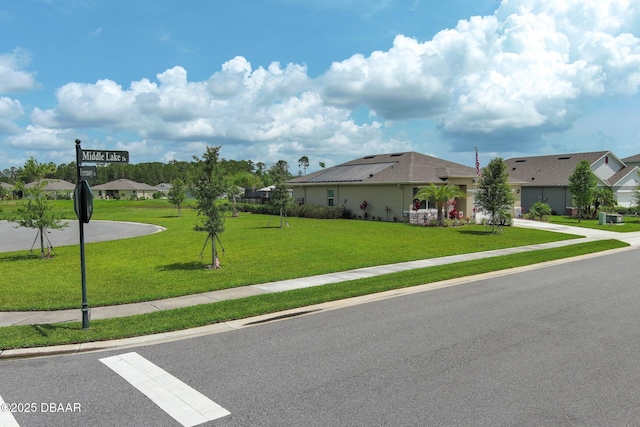 1313 Middle Lake Dr, Ormond Beach, FL 32174 - view of front of home featuring solar panels and a front lawn