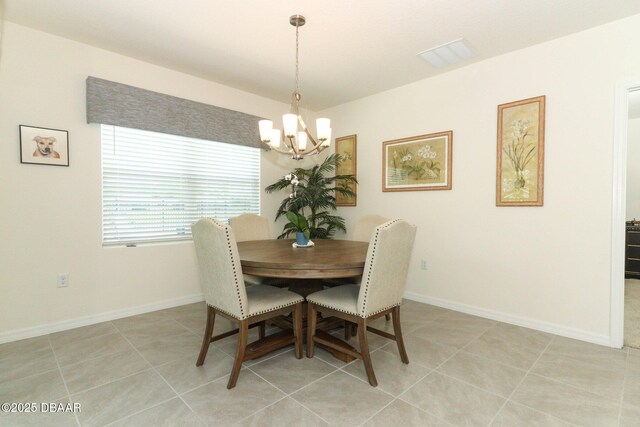 1313 Middle Lake Dr, Ormond Beach, FL 32174 - dining room featuring a chandelier, light tile patterned floors, and baseboards