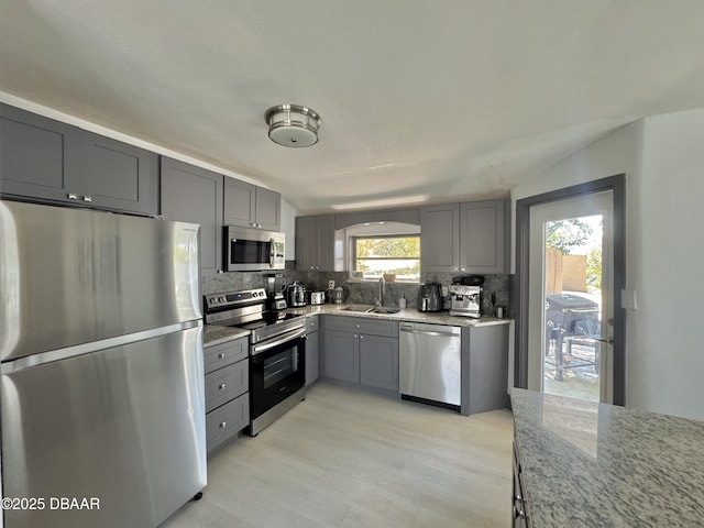 326 Ribault Ave, Daytona Beach, FL 32118 - kitchen featuring gray cabinets, a sink, light stone countertops, tasteful backsplash, and appliances with stainless steel finishes