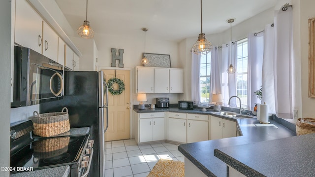 kitchen featuring a wealth of natural light, appliances with stainless steel finishes, sink, and hanging light fixtures