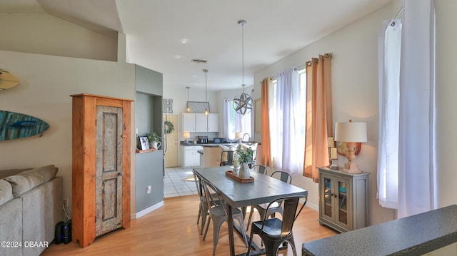 dining room featuring sink and light hardwood / wood-style floors