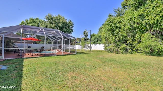 view of yard with a fenced in pool, a patio, and a lanai